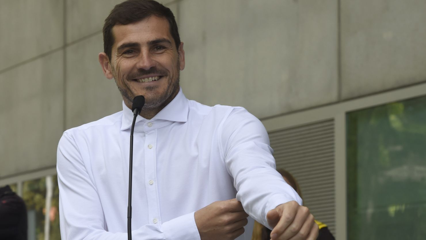 Iker Casillas smiles as he addresses journalists after leaving a hospital in Porto on Monday.