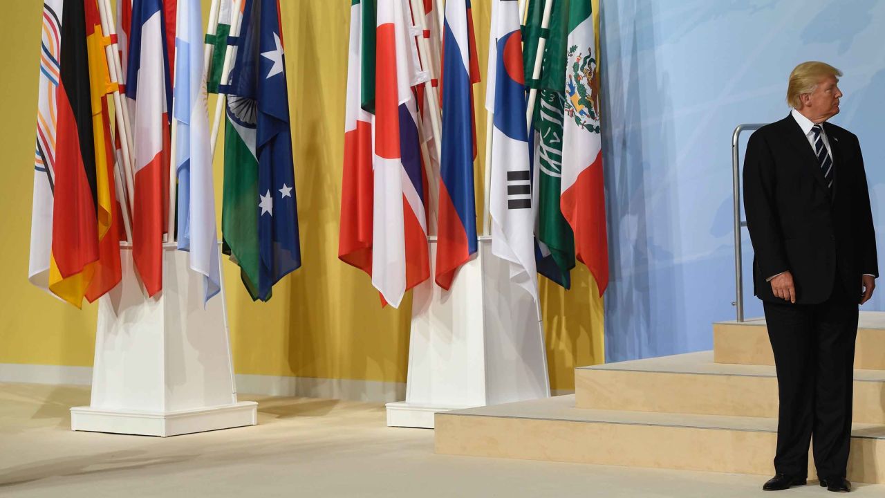 TOPSHOT - US President Donald Trump takes his place for the family photo on the first day of the G20 summit in Hamburg, northern Germany, on July 7, 2017.
Leaders of the world's top economies gather from July 7 to 8, 2017 in Germany for likely the stormiest G20 summit in years, with disagreements ranging from wars to climate change and global trade. / AFP PHOTO / SAUL LOEB        (Photo credit should read SAUL LOEB/AFP/Getty Images)