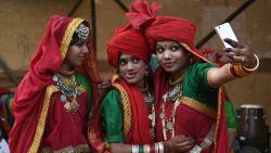 TOPSHOT - Indian artists from central India of Madhya Pradesh take selfie  before performing in a cultural event organised by Indira Gandhi National Centre for Arts in New Delhi on November 29, 2017. / AFP PHOTO / SAJJAD HUSSAIN        (Photo credit should read SAJJAD HUSSAIN/AFP/Getty Images)