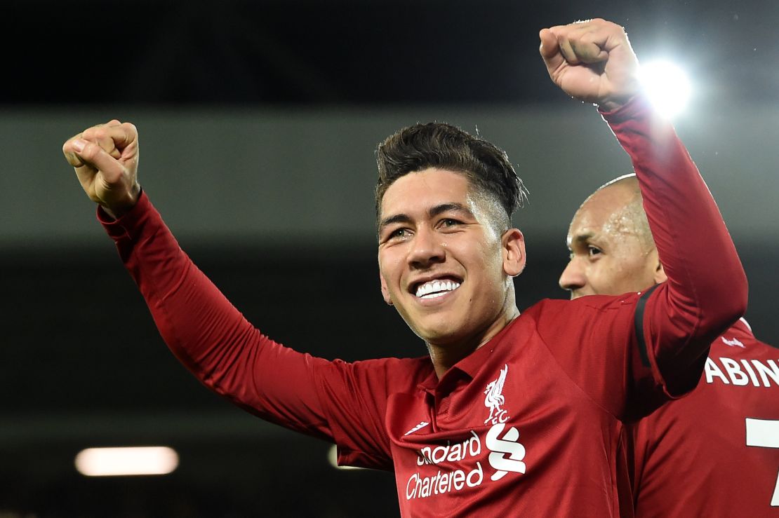 Roberto Firmino celebrates after scoring a hat-trick in his side's victory over Arsenal. 