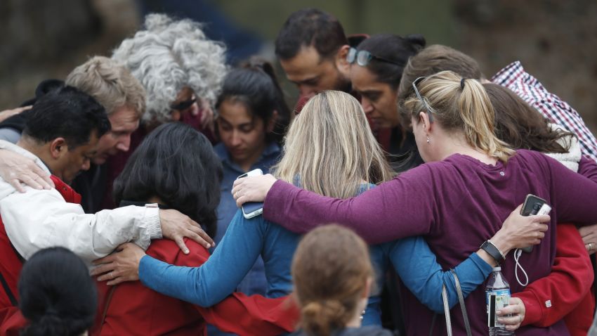 Parents gather in a circle to pray at a recreation center where students were reunited with their parents Tuesday, May 7, 2019, in Highlands Ranch, Colo. (AP Photo/David Zalubowski)