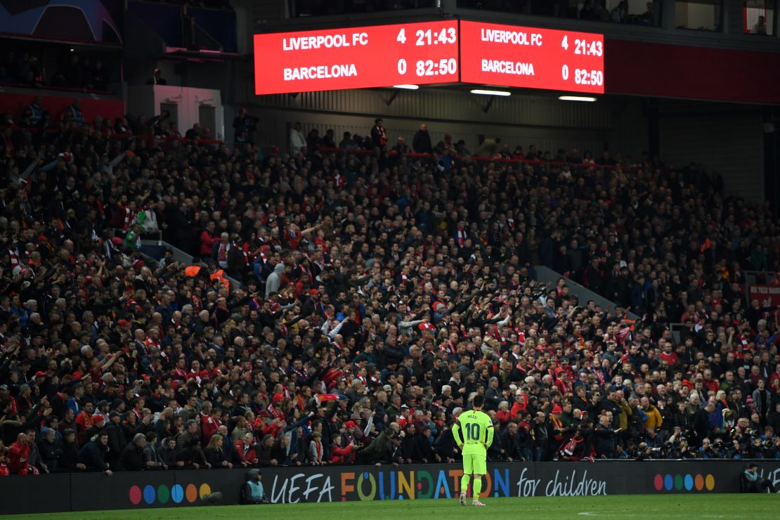 Messi looks dejected as the scoreboard reads '4-0' at Anfield.