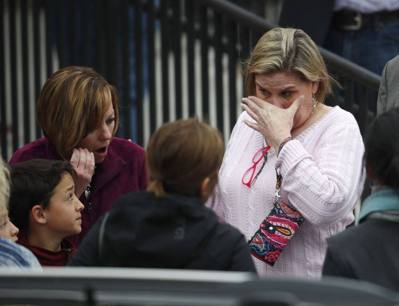 Parents fight back tears as they wait for their children at a recreation center.