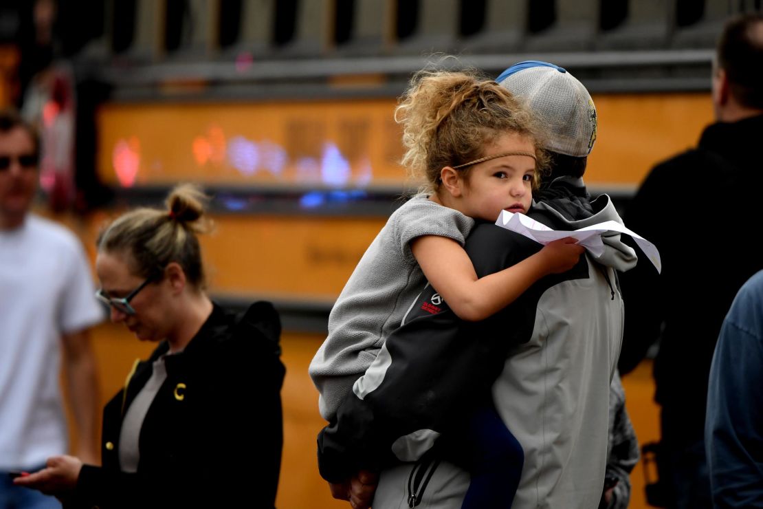 A child is held while waiting to get on their evacuation buses after a shooting at the STEM School Highlands Ranch on May 7.