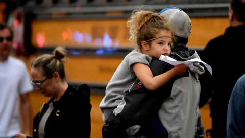A child is held while waiting to get on their evacuation buses after a shooting at the STEM School Highlands Ranch on May 7.