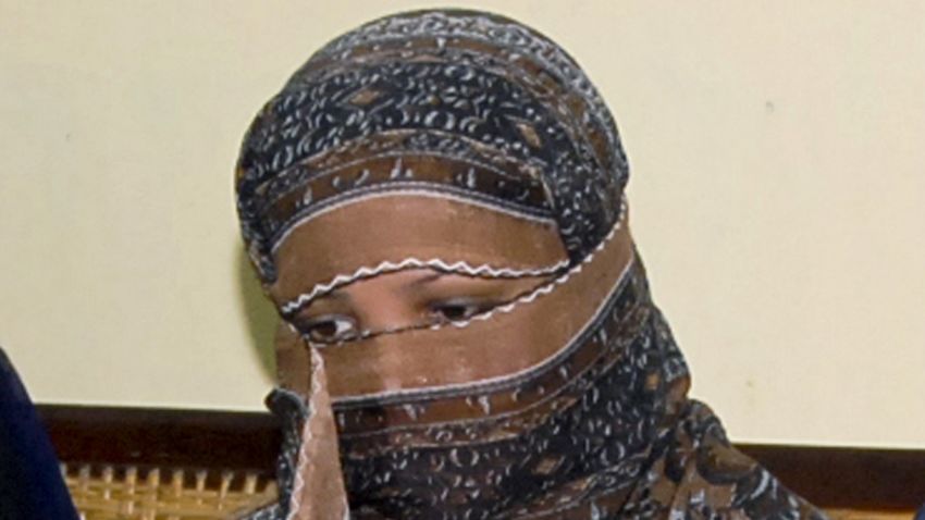 FILE - In this Nov. 20, 2010, file photo, Asia Bibi, a Pakistani Christian woman, listens to officials at a prison in Sheikhupura near Lahore, Pakistan. Italy is working to help relocate the family of a Pakistani Christian woman acquitted eight years after being sentenced to death for blasphemy, amid warnings from her husband that their life is in danger in Pakistan.  (AP Photo, File)