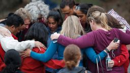 Parents gather in a circle to pray at a recreation center where students were reunited with their parents after a shooting at a suburban Denver middle school Tuesday, May 7, 2019, in Highlands Ranch, Colo. (AP Photo/David Zalubowski)