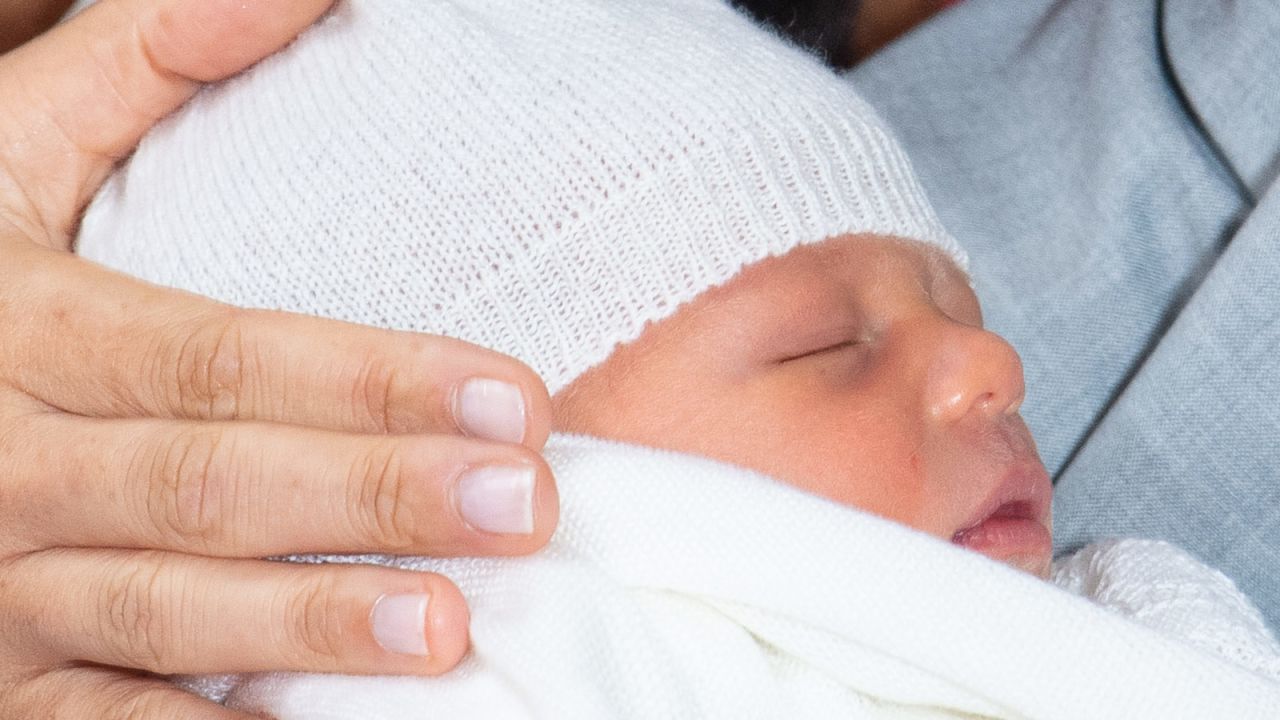 Prince Harry, Duke of Sussex and Meghan, Duchess of Sussex, pose with their newborn son Archie Harrison Mountbatten-Windsor in St. George's Hall at Windsor Castle on May 8, 2019.