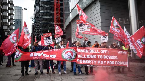 Uber drivers protest outside the Uber offices in London.