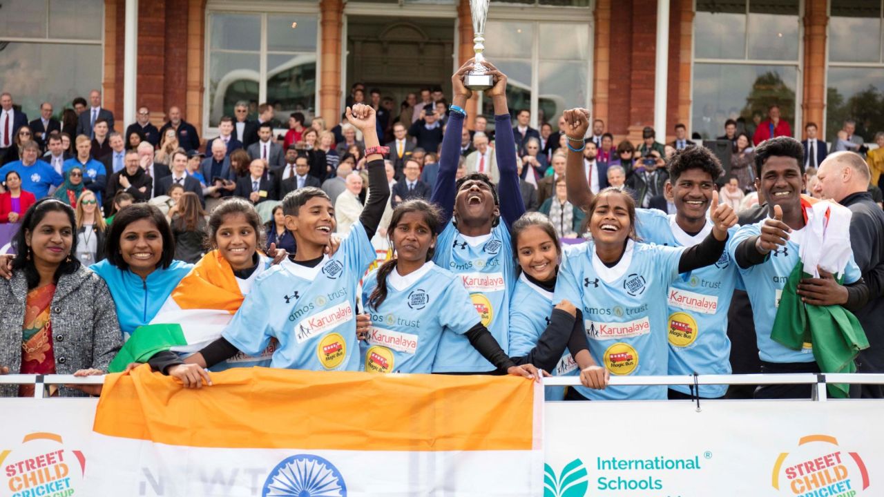 Nagalakshmi (left of trophy) and her India South team lifted the Street Child Cricket World Cup. 