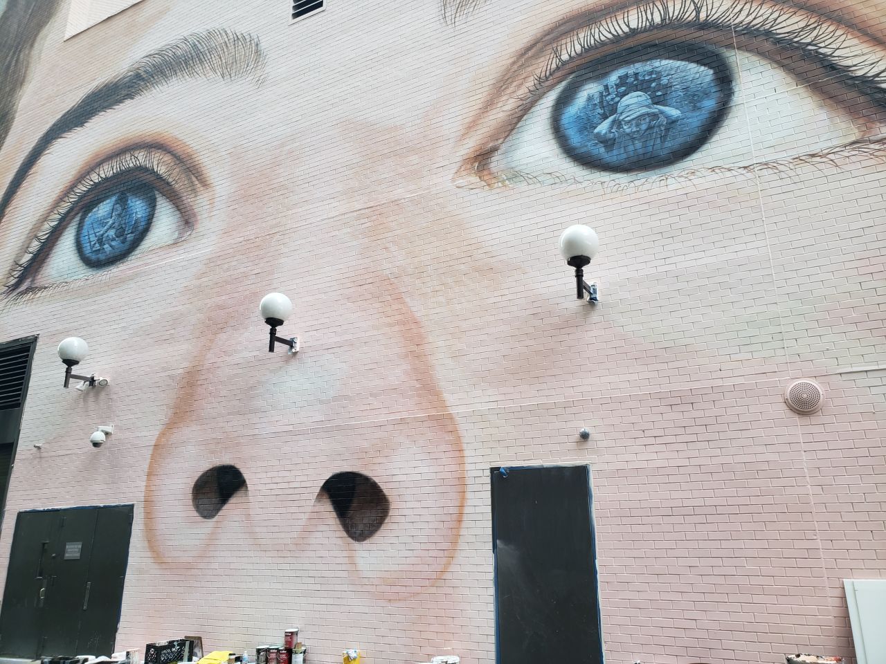 The mural is designed to raise awareness of child slavery. Inside the boy's two pupils are images of children rescued from child labor camps.
