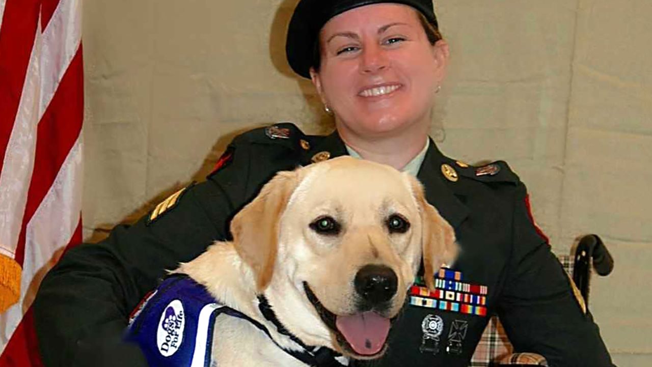 Harmony Allen in uniform with her service dog "Gunny" at a military event in Port St. Lucie, FL in 2016.