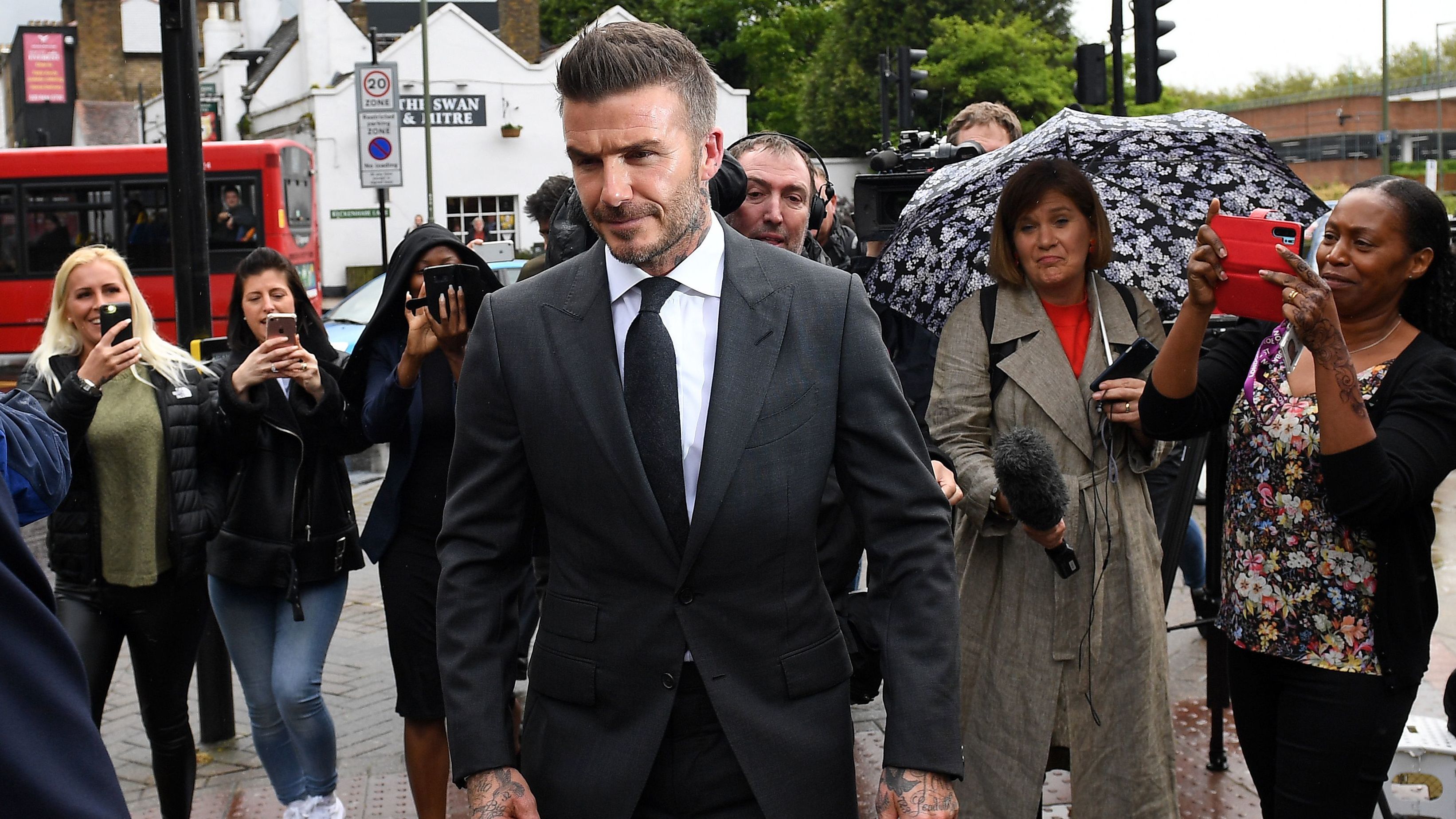 David Beckham leaves a court in southeast London after being banned from driving for six months.