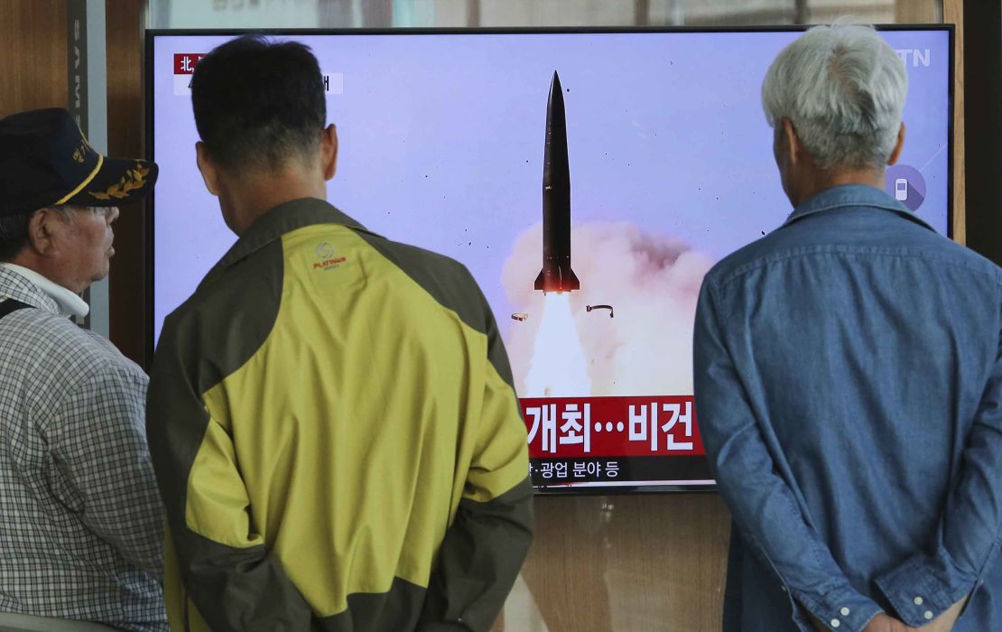 People watch a TV showing a file photo of North Korea's weapon systems during a news program at the Seoul Railway Station in Seoul, South Korea.