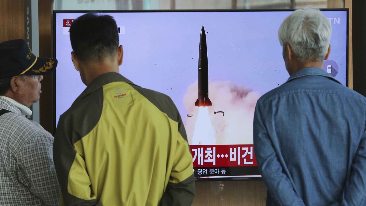 People watch a TV showing a file photo of North Korea's weapon systems during a news program at the Seoul Railway Station in Seoul, South Korea.