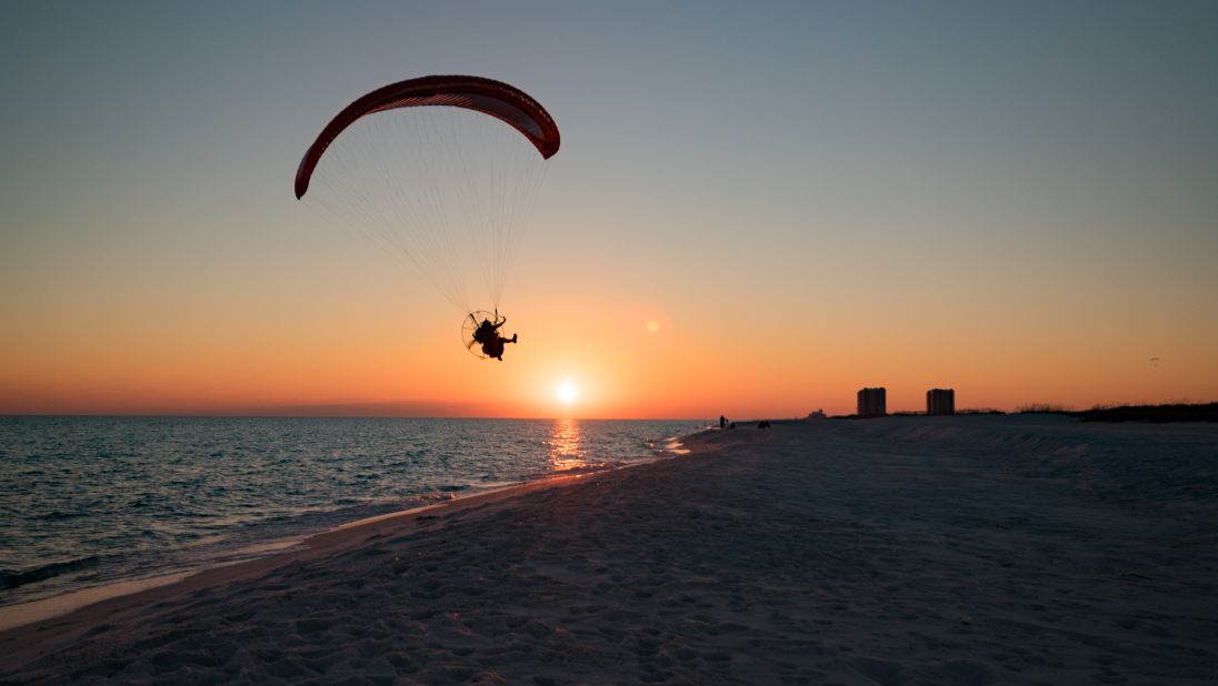 <strong>Pensacola Beach, Florida:</strong> A paraglider takes to the skies at sunset. Memorial Day Pensacola Beach Pride is the big event at the beach this time of year.