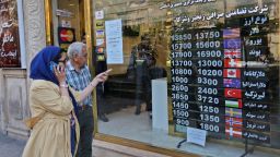 People walk past a currency exchange shop in the Iranian capital Tehran, on April 24, 2019. - Iranians, already hard hit by punishing US economic sanctions, are bracing for more pain after Washington abolished waivers for some countries which had allowed them to buy oil from Iran. (Photo by ATTA KENARE / AFP) / The erroneous mention[s] appearing in the metadata of this photo by ATTA KENARE has been modified in AFP systems in the following manner: [April 24, 2019] instead of [April 22]. Please immediately remove the erroneous mention[s] from all your online services and delete it (them) from your servers. If you have been authorized by AFP to distribute it (them) to third parties, please ensure that the same actions are carried out by them. Failure to promptly comply with these instructions will entail liability on your part for any continued or post notification usage. Therefore we thank you very much for all your attention and prompt action. We are sorry for the inconvenience this notification may cause and remain at your disposal for any further information you may require.        (Photo credit should read ATTA KENARE/AFP/Getty Images)