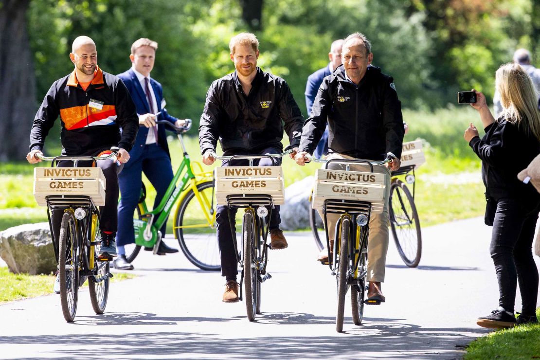 Former Dutch military sodlier and athlete Dennis van der Stroom, Britain's Prince Harry and host Lieutenant General Mart de Kruif ride bides during the presentation of The Invictus Games in The Hague.