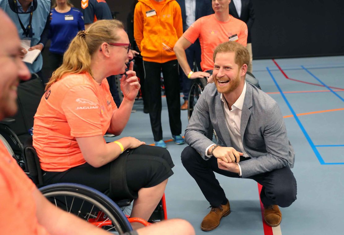 Prince Harry speaks with athletes during a sports training session at Sportcampus Zuiderpark.