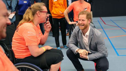 Prince Harry speaks with athletes during a sports training session at Sportcampus Zuiderpark.