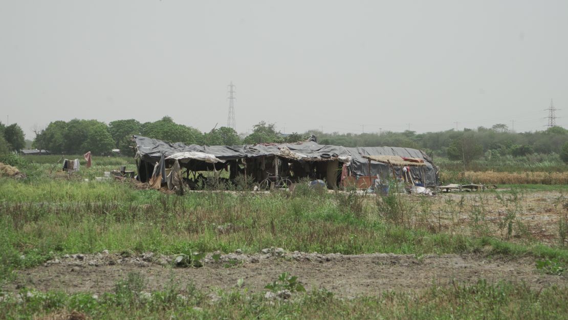 Mohammad Mujabir lives in a makeshift hut in the Yamuna River basin with his wive and five children. 