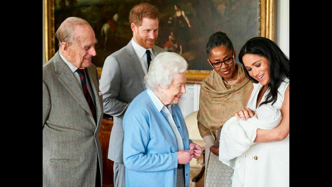 Britain's Queen Elizabeth II looks at her new great-grandchild, Archie, on Wednesday, May 8. <a href="http://www.cnn.com/2019/05/08/uk/gallery/archie-royal-baby-harry-meghan/index.html" target="_blank">Archie</a> is the first child of Prince Harry, second from left, and his wife Meghan, the Duchess of Sussex. Prince Philip is on the far left. Meghan's mother, Doria Ragland, is next to her at right.