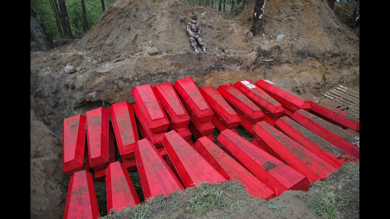 Coffins carrying the remains of Soviet soldiers killed in World War II are buried at a memorial near the Russian village of Sinyavino on Tuesday, May 7. The remains of nearly 1,000 soldiers were recently recovered from a former battlefield.