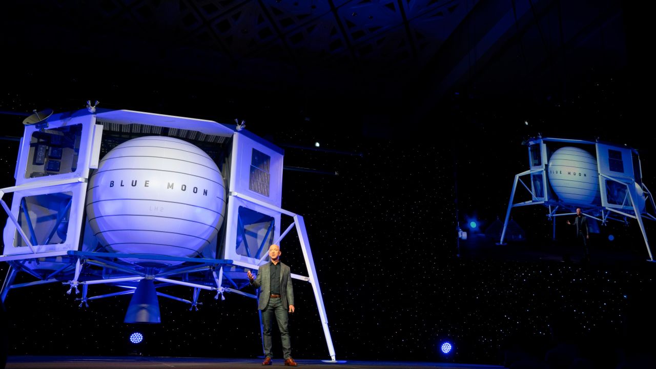 Jeff Bezos stands in front of a Blue Origin prototype of a lunar lander named Blue Moon.