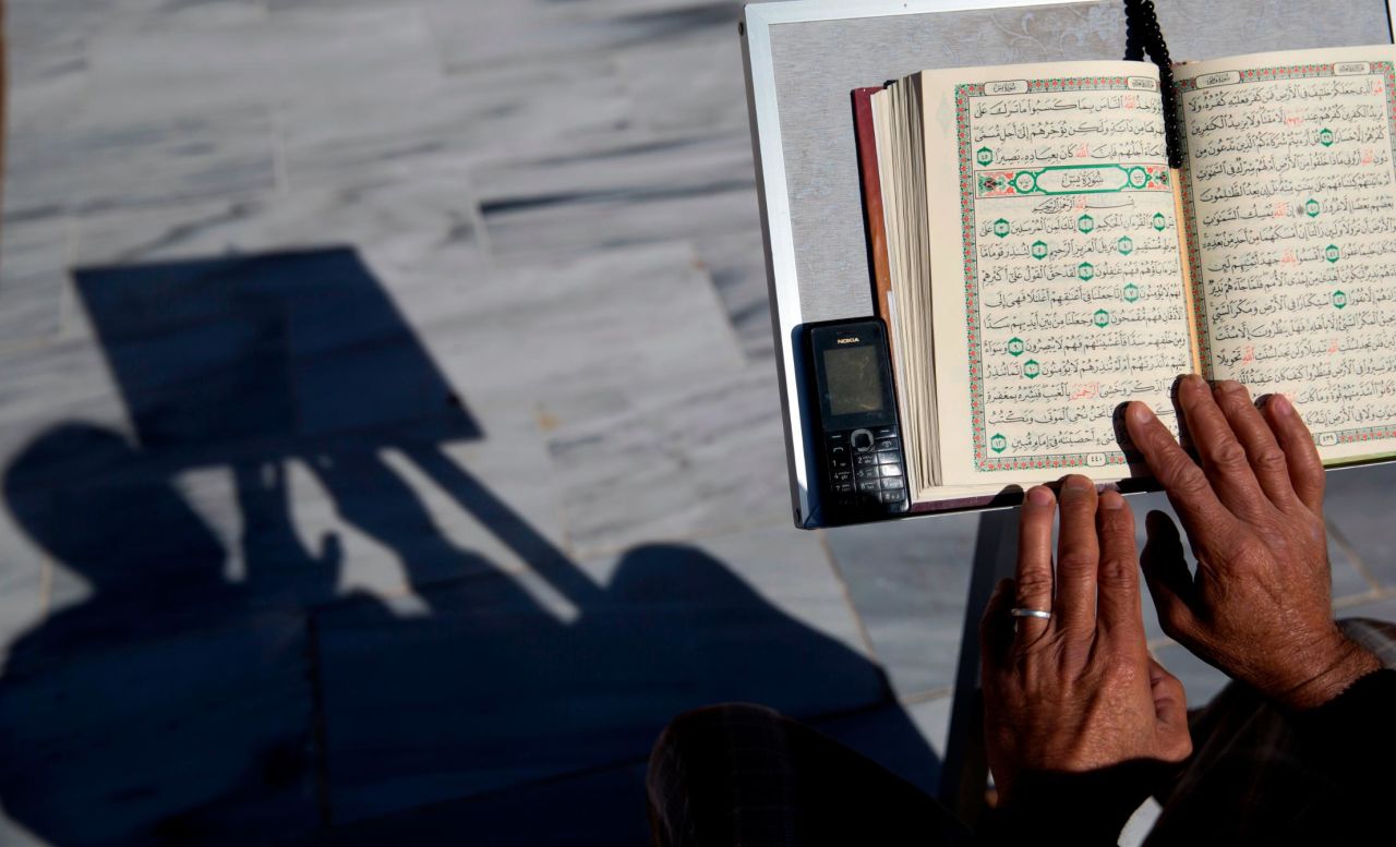 A Palestinian man reads verses of the Quran at Al Emari mosque in Gaza City, Wednesday, May 8.