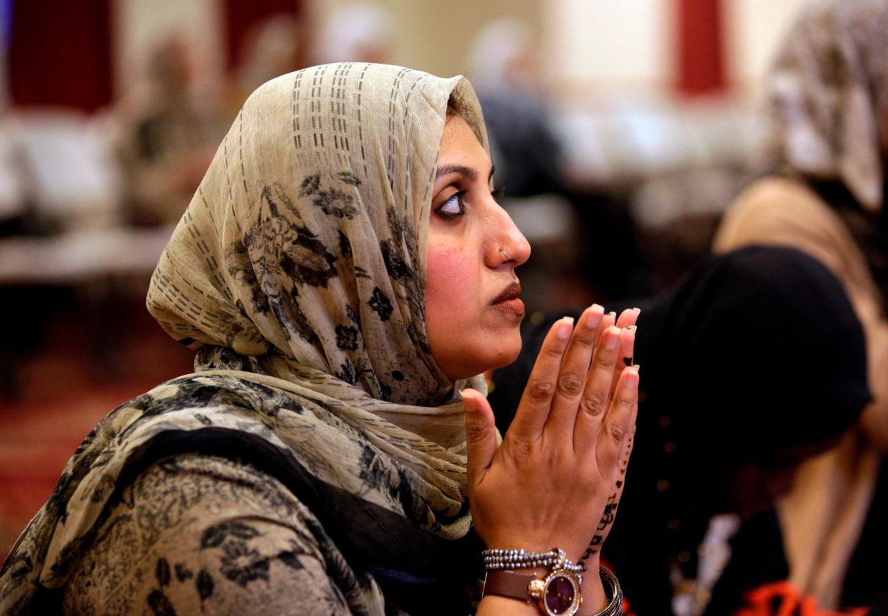 A Muslim woman prays after breaking fast at sunset at the Islamic Center of Greater Miami.