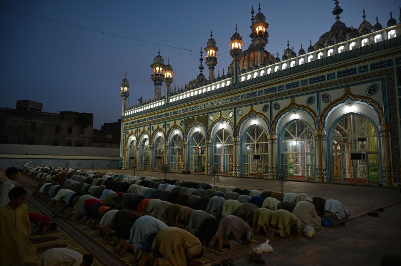 Pakistani Muslim devotees offer evening prayers after breaking their fast on the first day of Ramadan at a mosque in Rawalpindi.