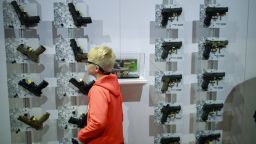 INDIANAPOLIS, INDIANA, UNITED STATES - 2019/04/27: A boy looks at hand guns in the Sig Sauer booth during the third day of the National Rifle Association convention. (Photo by Jeremy Hogan/SOPA Images/LightRocket via Getty Images)