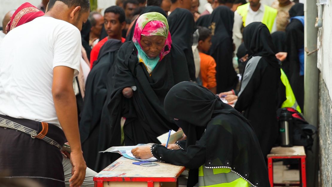 Women line up to ask for  international aid in Yemen.