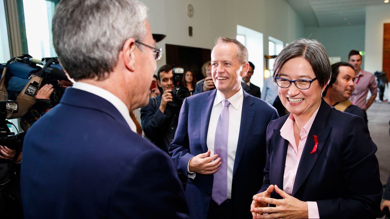 Labor Senator Penny Wong (R) and Labor opposition leader Bill Shorten (C) celebrate after parliament passed the same-sex marraige bill on December 7, 2017. 