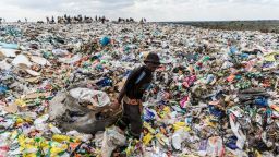 TOPSHOT - A recycler drags a huge bag of paper sorted for recycling past a heap of non-recyclable material at Richmond sanitary landfill site on 2 June 2018 in the industrial city of Bulawayo. - Plastic waste remains a challenging waste management issue due to its non-biodegrable nature, if not managed properly plastic end up as litter polluting water ways, wetlands and storm drains causing flash flooding around Zimbabwe's cities and towns. Urban and rural areas are fighting the continuous battle against a scourge of plastic litter. On June 5, 2018 the United Nations mark the World Environment Day which plastic pollution is the main theme this year. (Photo by Zinyange Auntony / AFP)        (Photo credit should read ZINYANGE AUNTONY/AFP/Getty Images)