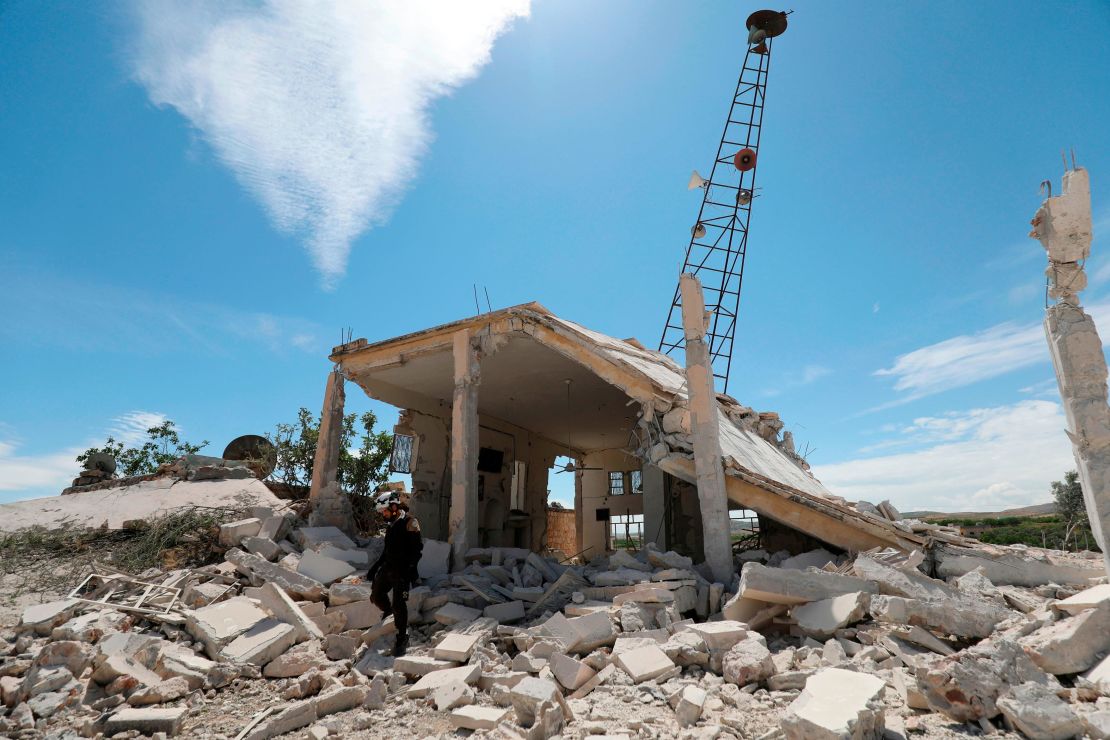 A Syrian Civil Defense member inspects the rubble following shelling in the village of Maarit Sin Saturday. 