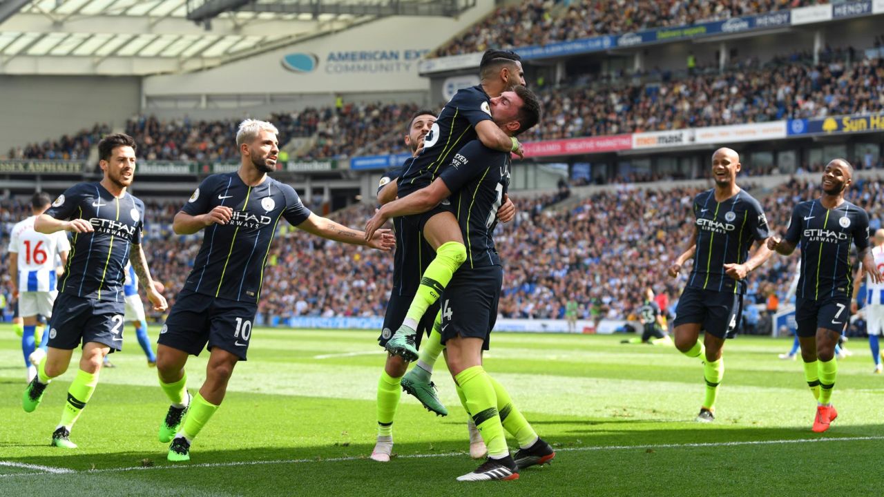 Man City players celebrate taking the lead againt Brighton