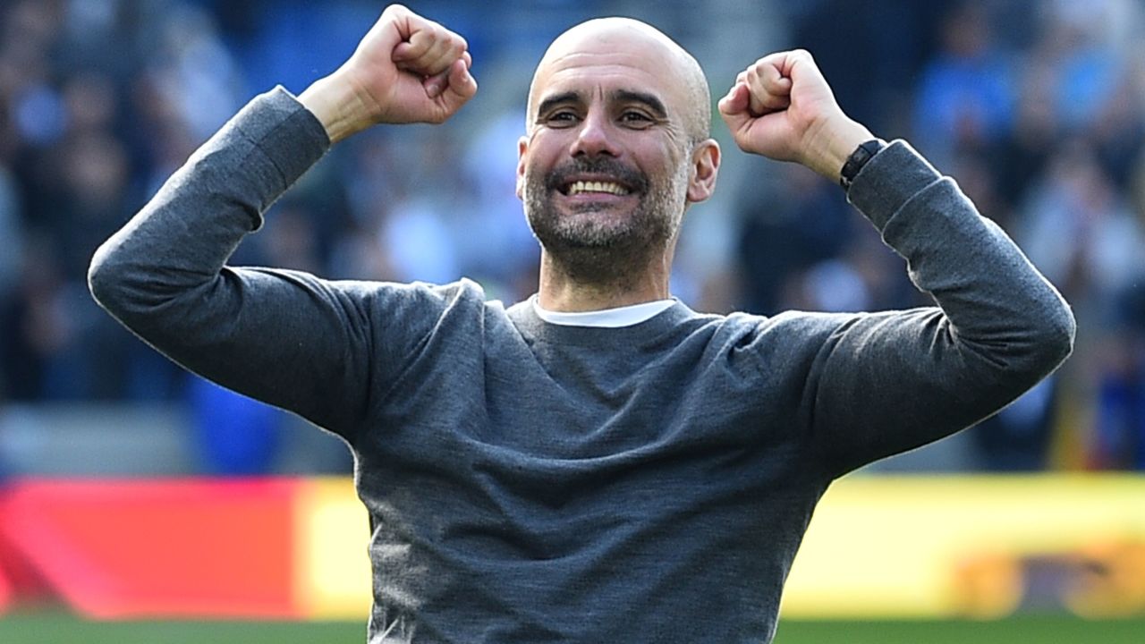 Pep Guardiola celebrates winning his second title with Man City