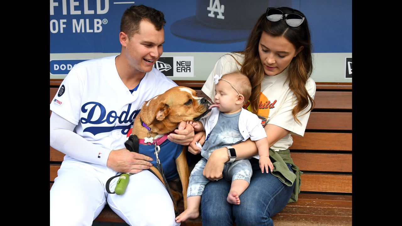 Joc Pederson of the Los Angeles Dodgers poses with his wife Kelsey, dog Blue and daughter Poppy as more than 700 dogs attend the game between the Dodgers and the Washington Nationals for the annual Pups at the Park promotion at Dodger Stadium on May 11 in Los Angeles.