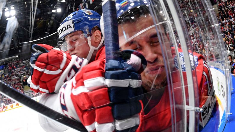 Jakub Vrana of the Czech Republic (left) checks Mattias Norstebo of Norway (right) during the IIHF World Championship group B ice hockey match between Norway and Czech Republic on May 11 at the Ondrej Nepela Arena in Bratislava, Slovakia.