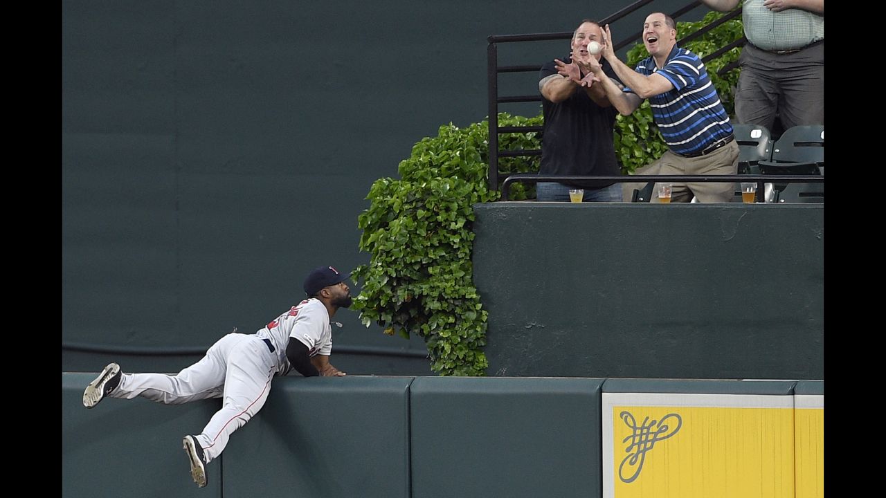 Boston Red Sox center fielder Jackie Bradley Jr. watches fans go for a ball hit by the Baltimore Orioles' Jonathan Villar for a grand slam during the second inning of a baseball game on May 6 in Baltimore.