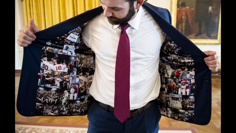 Mitch Moreland of the Boston Red Sox displays his jacket as he takes a tour during a visit to the White House in recognition of the 2018 World Series championship, on May 9 Washington.