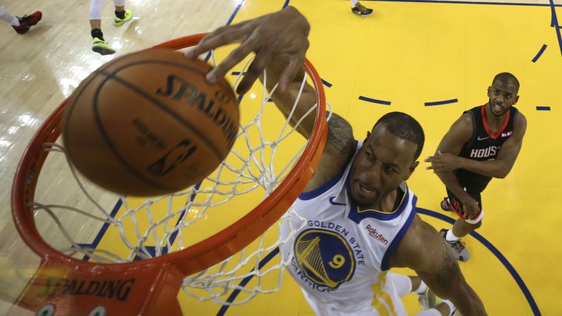 Golden State Warriors guard Andre Iguodala dunks the basketball against Houston Rockets guard Chris Paul during the first half of game five of the second round of the 2019 NBA Playoffs at Oracle Arena in Oakland, California.