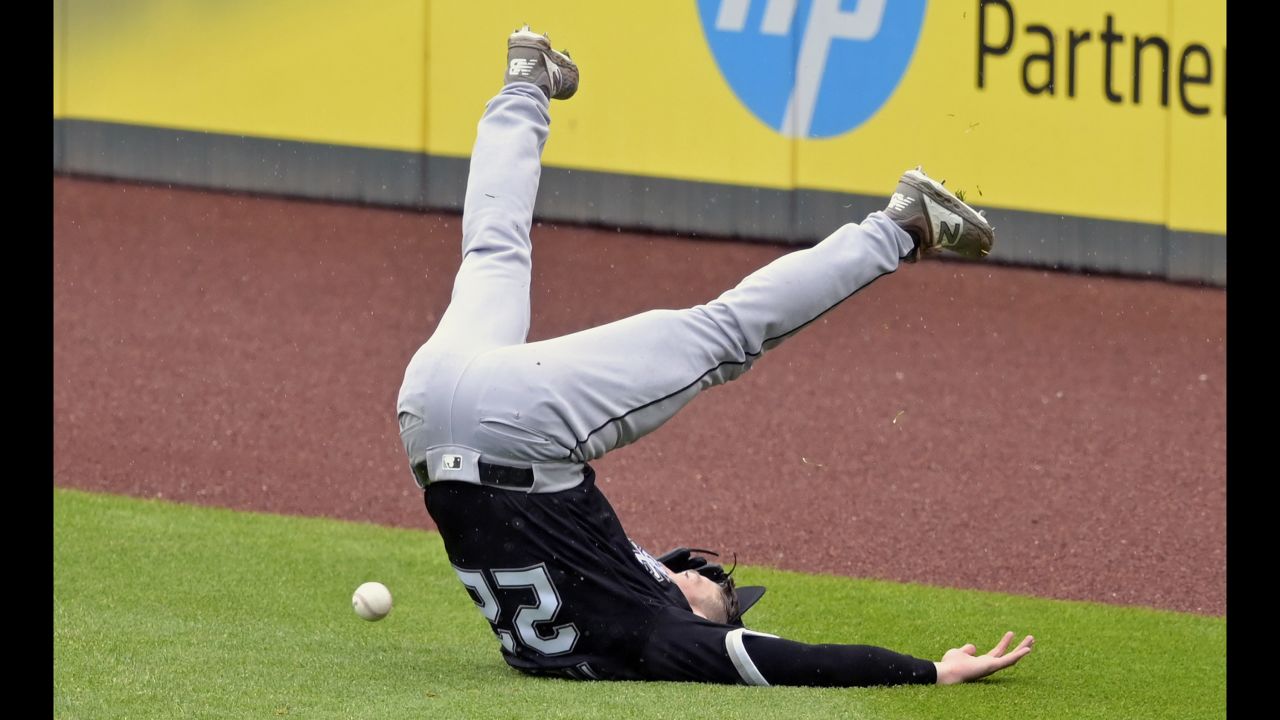 Chicago White Sox right fielder Charlie Tilson (22) loses his balance while reaching for a double by Cleveland Indians shortstop Francisco Lindor (not pictured) in the fifth inning at Progressive Field. 