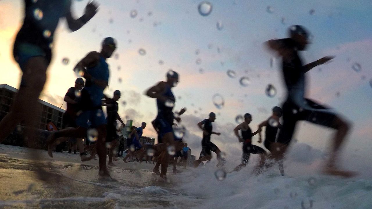 Athletes in the Pro Men's division enter the water during the run portion of IRONMAN 70.3 Gulf Coast on May 11, 2019, in Panama City, Florida. The triathlon returns to the Panama City Beach welcoming over 2,000 registered participants and marking IRONMAN's return to the Florida Panhandle for the first time since the area was hit by Hurricane Michael in October of 2018.