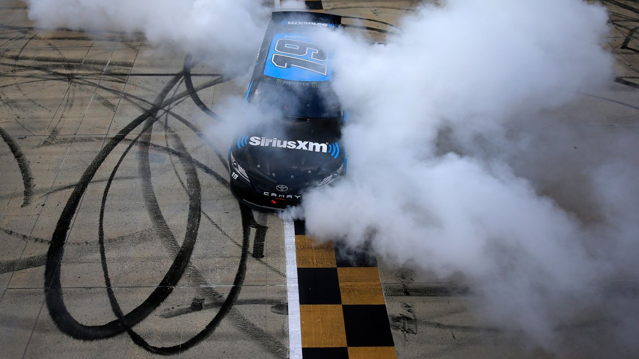 Martin Truex Jr., driver of the #19 SiriusXM Toyota, celebrates with a burnout following his victory in the Monster Energy NASCAR Cup Series Gander RV 400 at Dover International Speedway on May 6, 2019, in Dover, Delaware.  