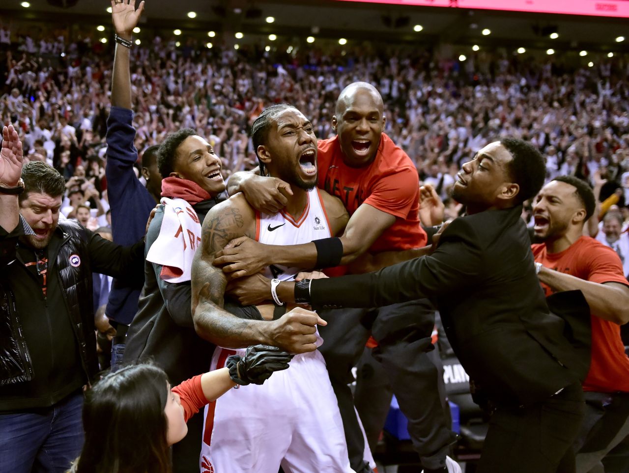 Toronto Raptors forward Kawhi Leonard, center, celebrates his game-winning basket as time expired at the end of an NBA Eastern Conference semifinal basketball game against the Philadelphia 76ers, in Toronto on Sunday, May 12. Toronto won 92-90.