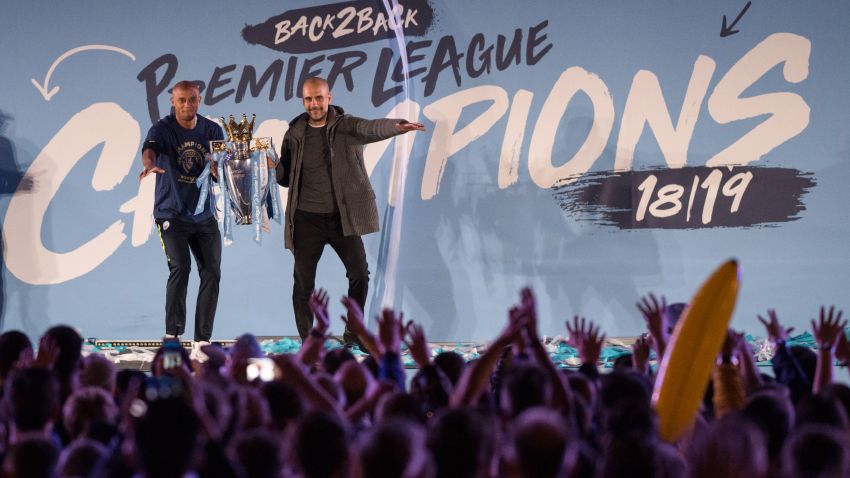 Manchester City's Spanish manager Pep Guardiola (R) and Manchester City's Belgian defender Vincent Kompany (L) show the Premier League trophy to supporters outside the Etihad Stadium in Manchester, northern England on May 12, 2019 - Manchester City held off a titanic challenge from Liverpool to become the first side in a decade to retain the Premier League on Sunday by coming from behind to beat Brighton 4-1 on Sunday. (Photo by OLI SCARFF / AFP)        (Photo credit should read OLI SCARFF/AFP/Getty Images)