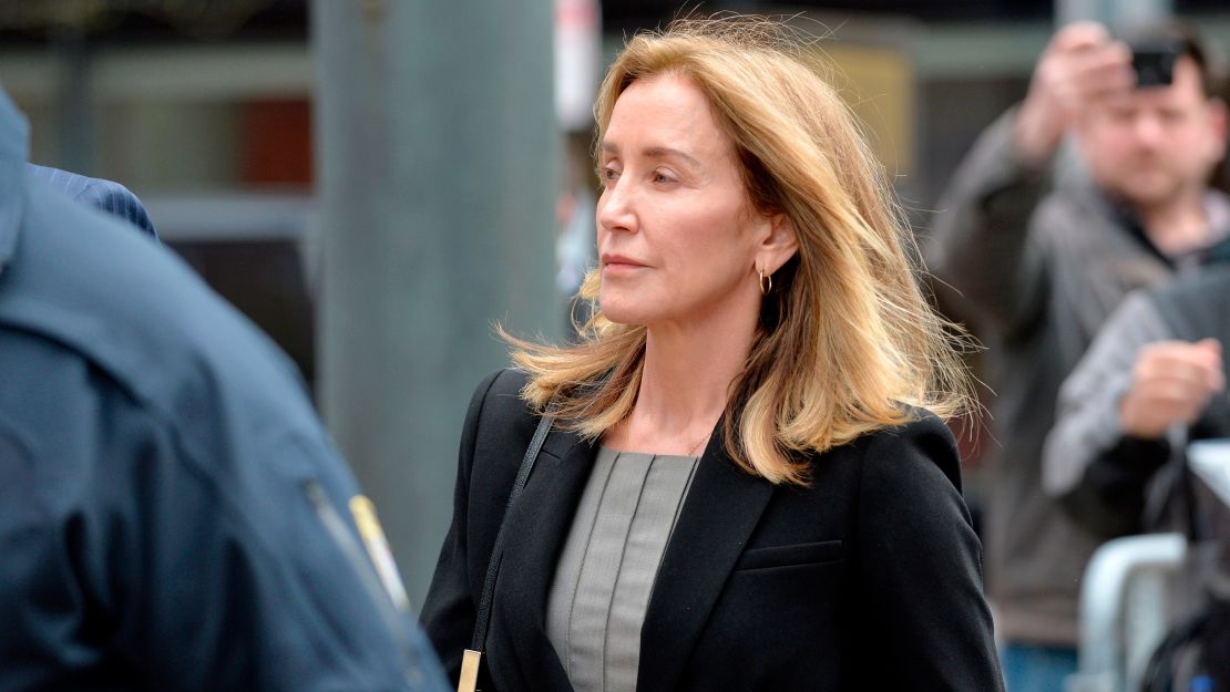 Actress Felicity Huffman is escorted into court Monday in Boston, where she is expected to plead guilty to one count of conspiracy to commit mail fraud and honest services mail fraud.