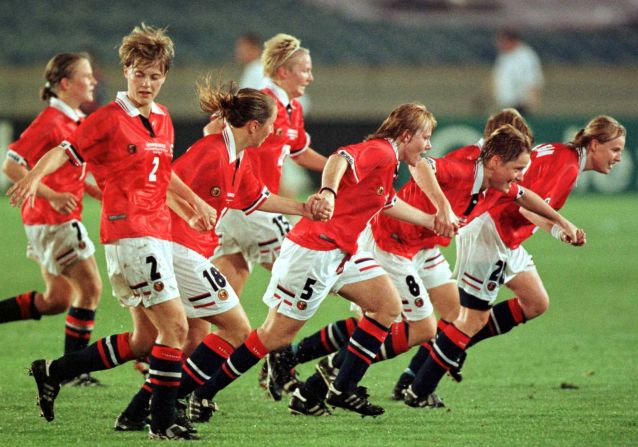 Norway would top Group C. Here the team prepares to slide on the turf in unison after a thumping 4-0 thumping of Japan on a rain-drenched Soldier Field in Chicago, Illinois.